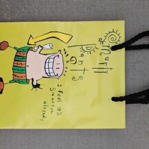 Playful Design: Features the "Smarty Pants" character with a fun lightbulb "idea" graphic and the humorous caption: "I feel 10% Smarter already". Vibrant Color Palette: The bold yellow background and colorful character artwork make this bag stand out for birthdays, graduations, or "just because" gifts. Durable Construction: Made from high-quality reinforced paper with sturdy, black braided cord handles for comfortable and secure carrying. Versatile Size: Ideal for books, small electronics, or a variety of medium-sized treats and surprises.